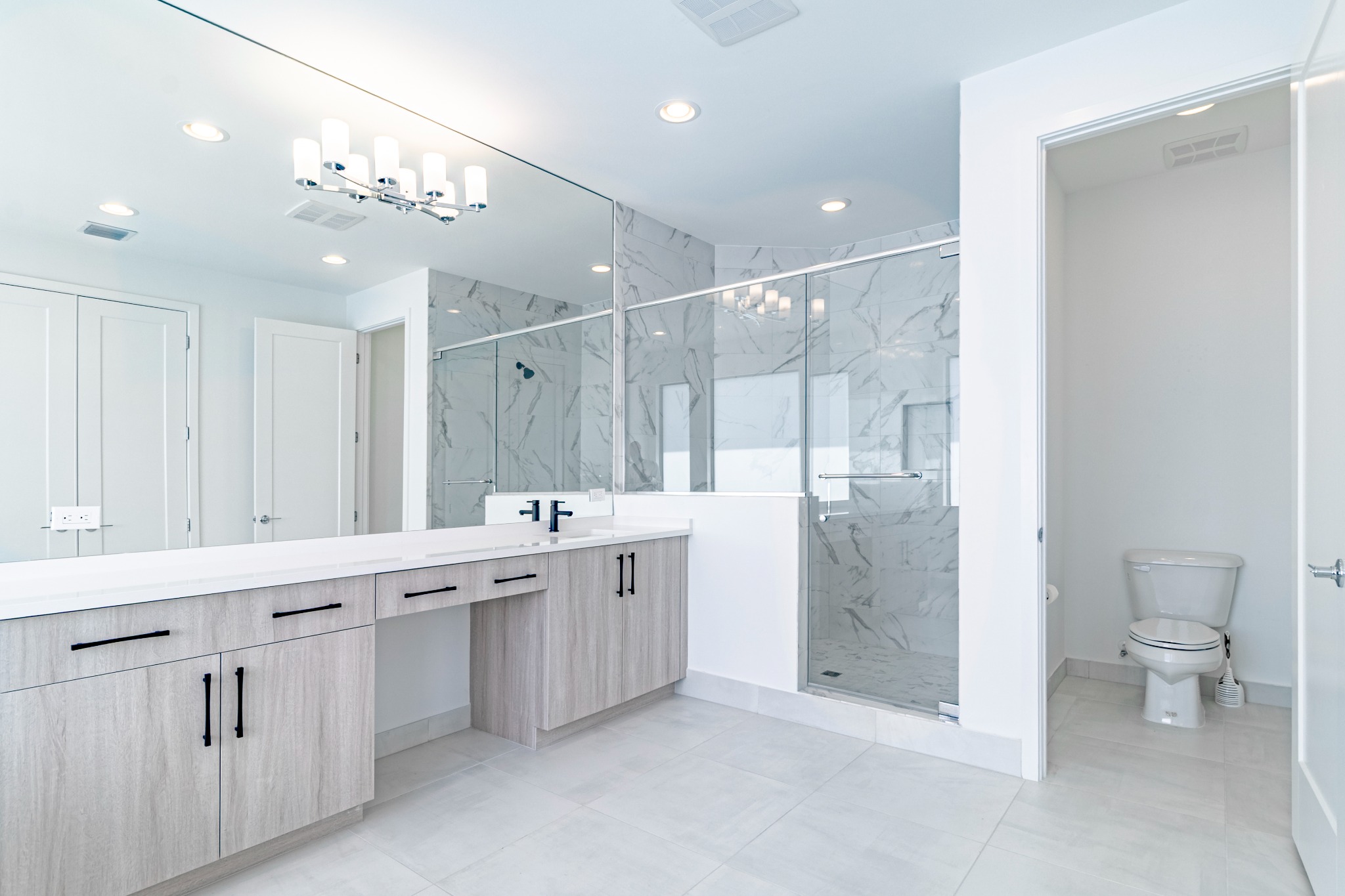 Primary bathroom vanity and glass shower